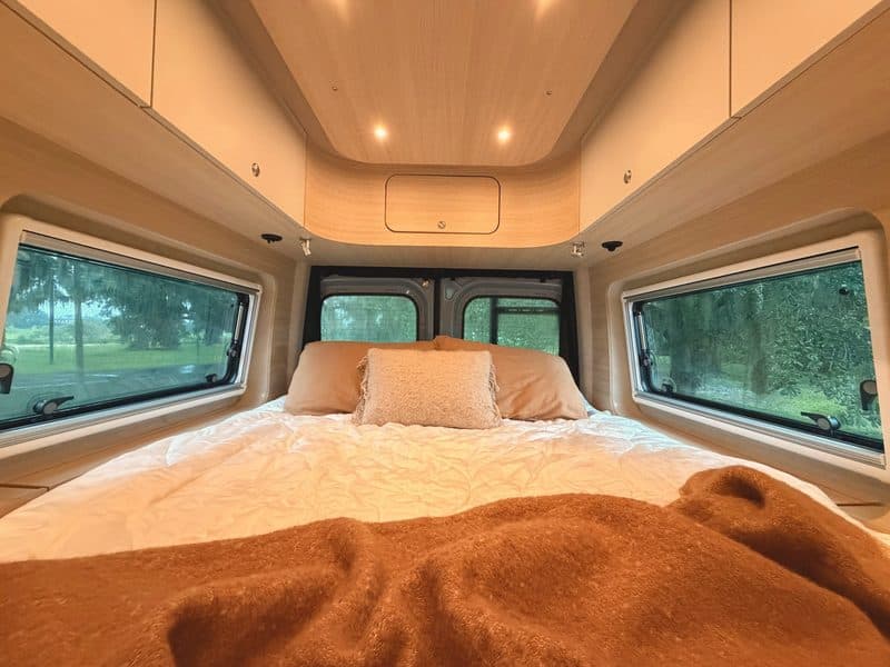 Nellie's bed, with windows looking out to live oaks