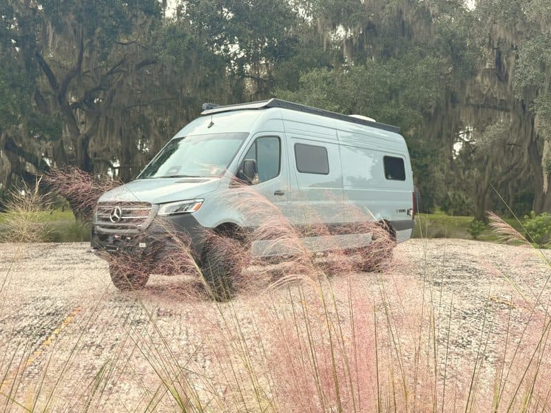 Nellie parked in pink muhly grass under live oaks