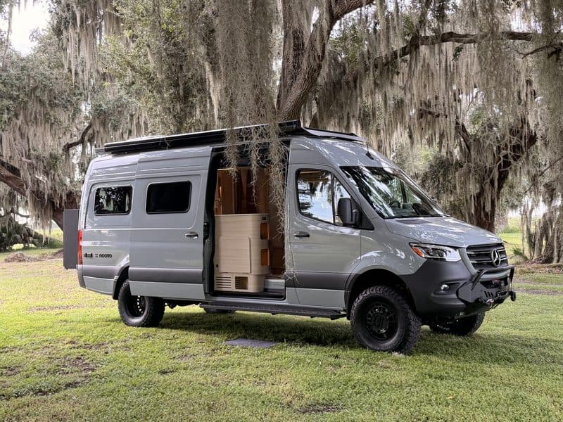 Nellie with the sliding door open under moss-draped live oaks