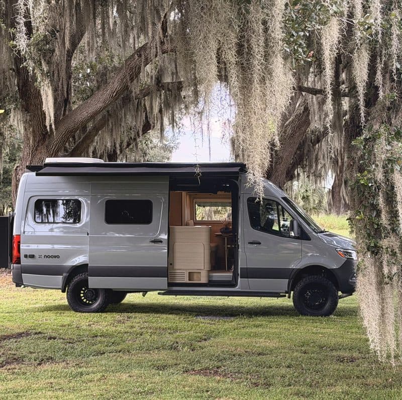 Nellie parked under live oaks with the sliding door open