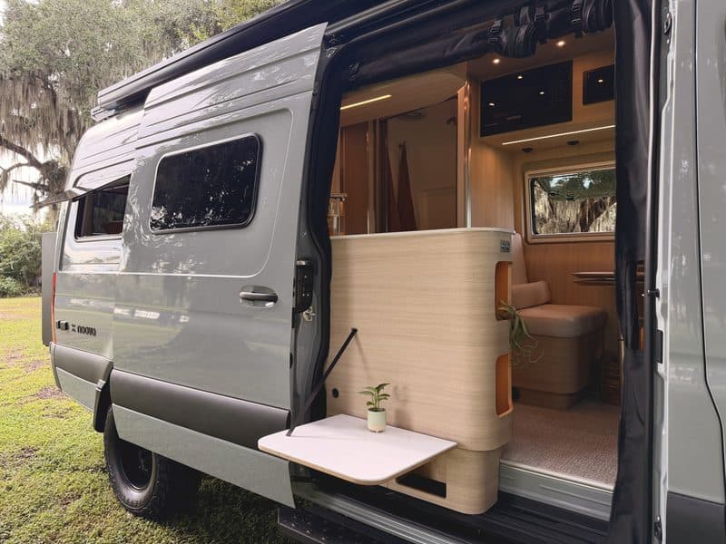 The sliding door open, with the fold-out table and galley cabinet