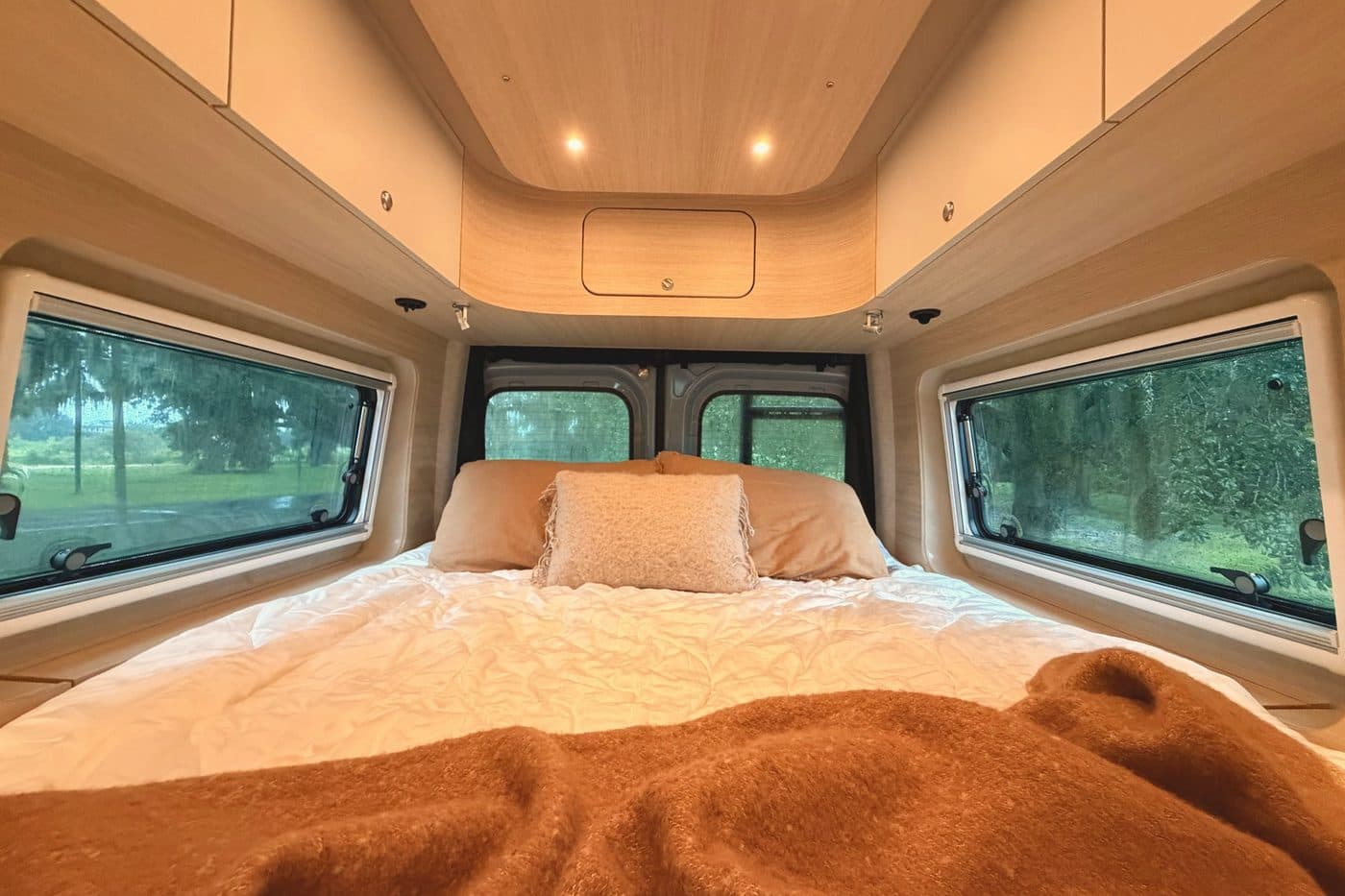 Nellie's bed, with windows looking out to live oaks