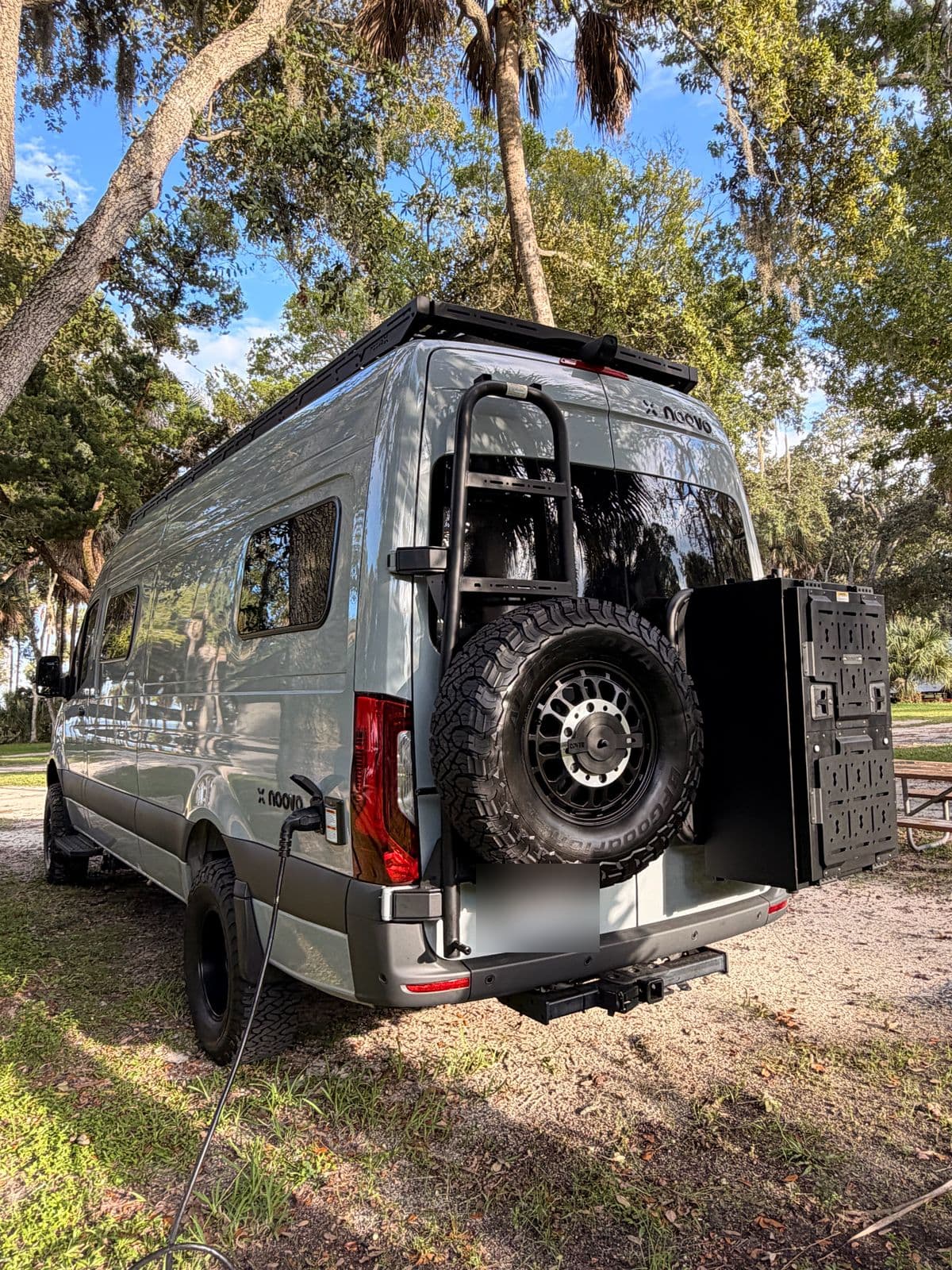 Nellie from the rear at site 69, plugged into shore power under live oaks